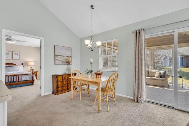 dining room with high vaulted ceiling, light colored carpet, ceiling fan with notable chandelier, and baseboards