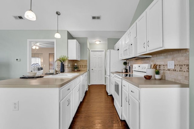 kitchen featuring visible vents, white cabinets, white appliances, and a sink