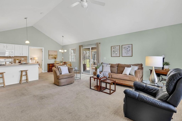 living area with light carpet, high vaulted ceiling, and ceiling fan with notable chandelier