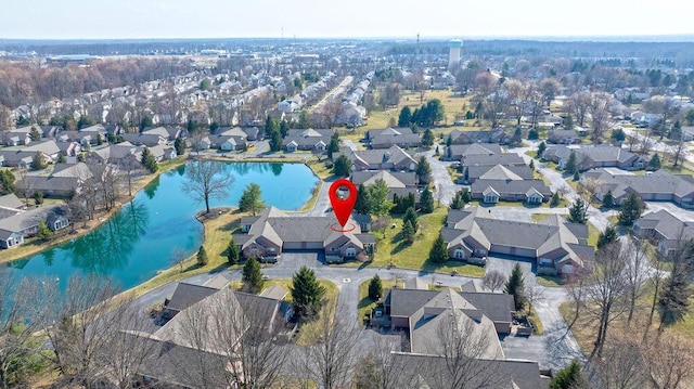 drone / aerial view featuring a residential view and a water view