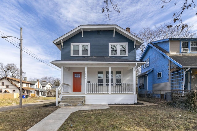 view of front of house featuring covered porch and a front lawn