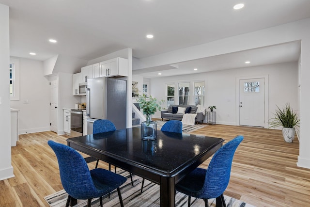 dining space with light wood-type flooring