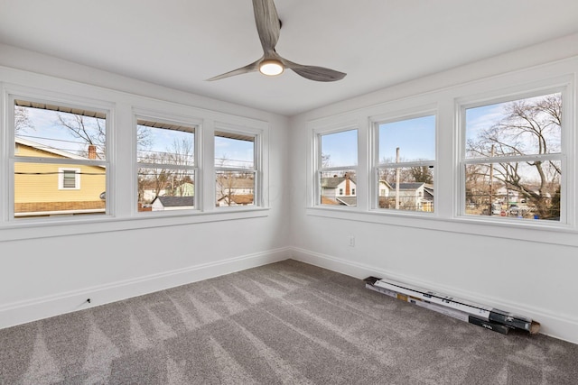 unfurnished sunroom with ceiling fan