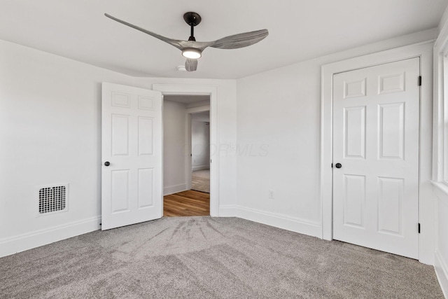 unfurnished bedroom with ceiling fan and carpet