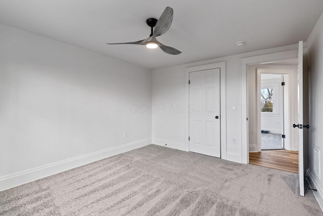 unfurnished bedroom with ceiling fan and carpet floors