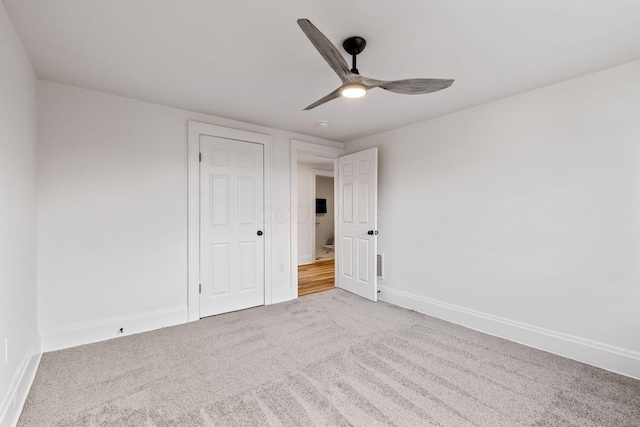 spare room featuring carpet and ceiling fan