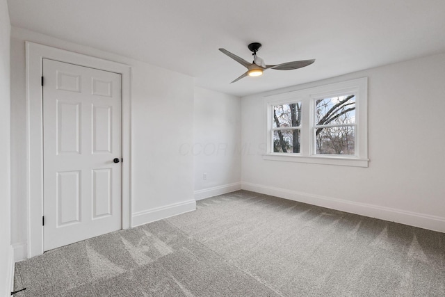 carpeted empty room featuring ceiling fan