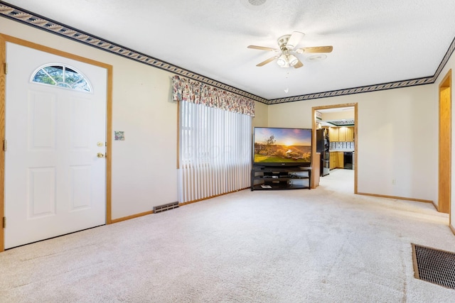 unfurnished living room with a healthy amount of sunlight, light colored carpet, and ceiling fan