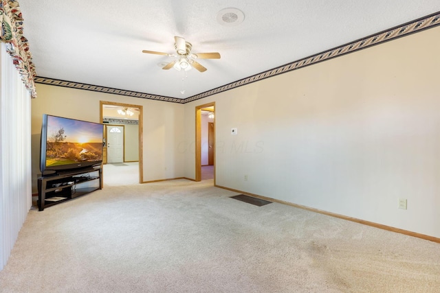 unfurnished living room with light carpet, ceiling fan, and a textured ceiling