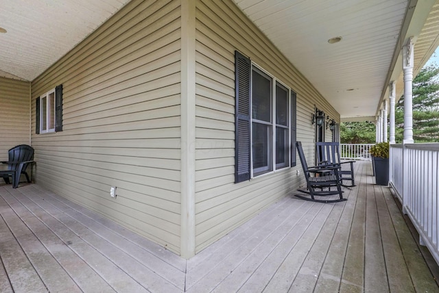 wooden terrace with a porch