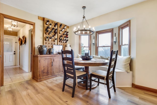 dining space with an inviting chandelier and light hardwood / wood-style floors