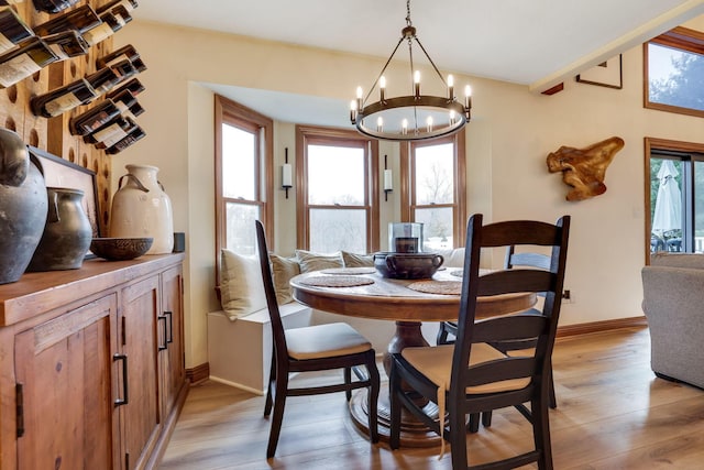 dining area featuring a notable chandelier and light hardwood / wood-style flooring