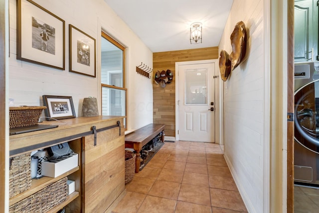 hallway with light tile patterned flooring and wooden walls