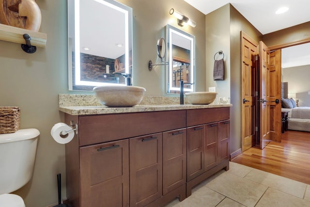 bathroom featuring vanity, tile patterned floors, and toilet