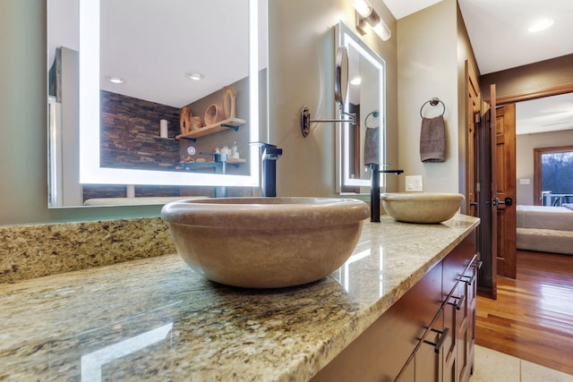 room details with vanity and hardwood / wood-style floors