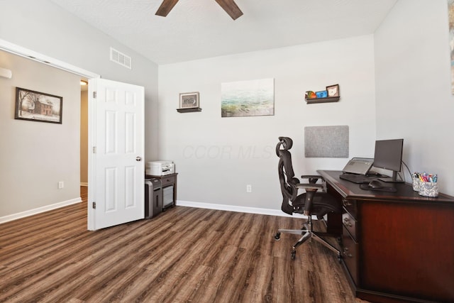 home office with baseboards, dark wood finished floors, visible vents, and a ceiling fan