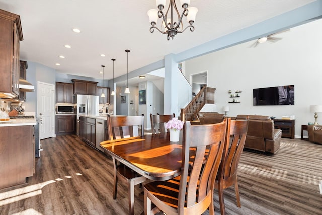 dining room with recessed lighting, baseboards, stairway, dark wood finished floors, and an inviting chandelier