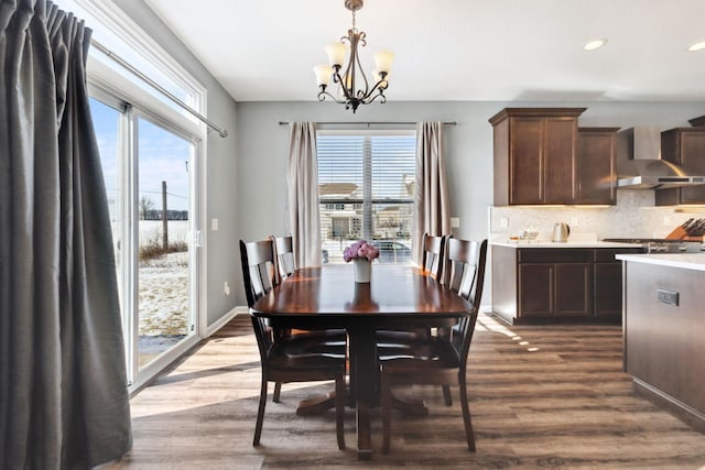 dining room featuring baseboards, a chandelier, dark wood-type flooring, and recessed lighting