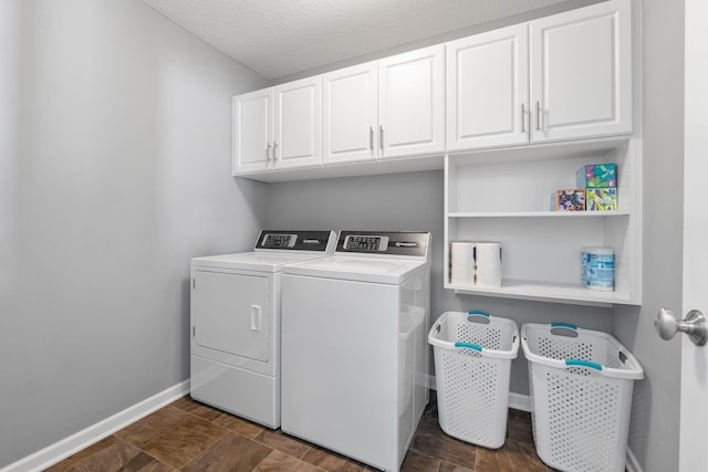 laundry area featuring dark wood-type flooring, cabinet space, washer and clothes dryer, and baseboards