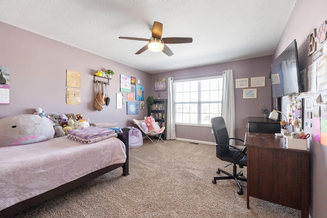 bedroom featuring carpet, baseboards, ceiling fan, and a textured ceiling