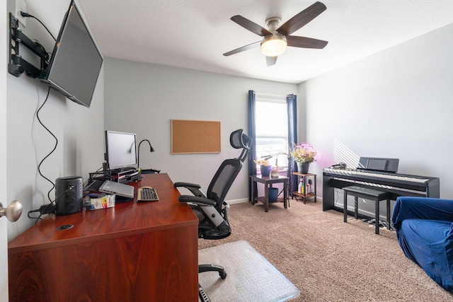 carpeted home office featuring a ceiling fan and baseboards