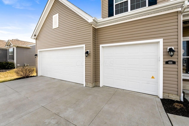 garage with concrete driveway