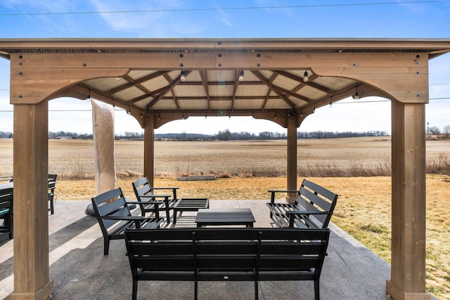 view of patio with a gazebo and a rural view