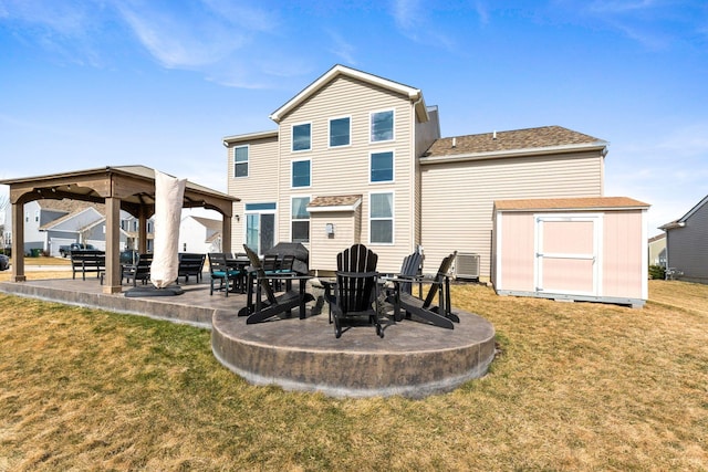 back of property featuring a lawn, an outbuilding, a gazebo, a patio area, and a shed