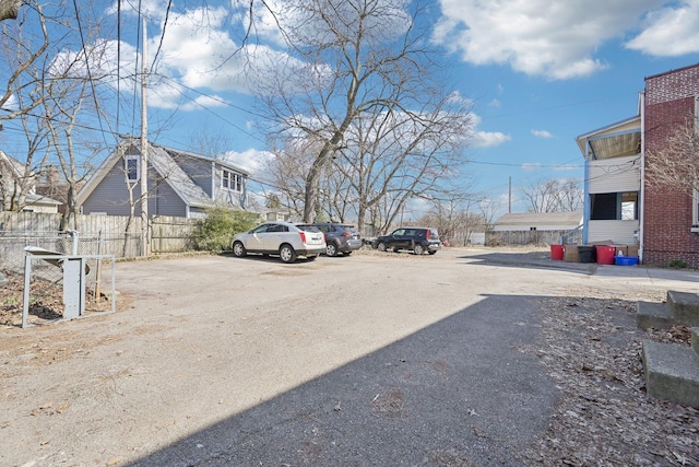 uncovered parking lot featuring fence