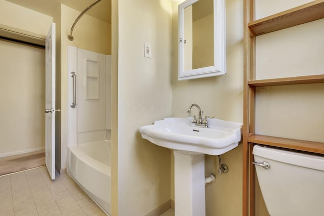 bathroom with toilet, tile patterned floors, and shower / bathing tub combination