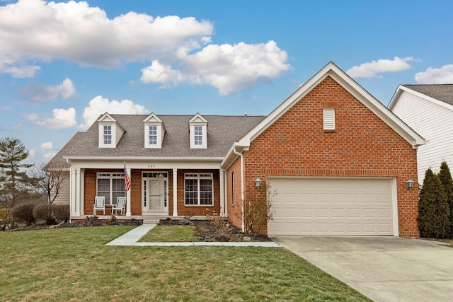 view of front facade with a garage, a front yard, and covered porch