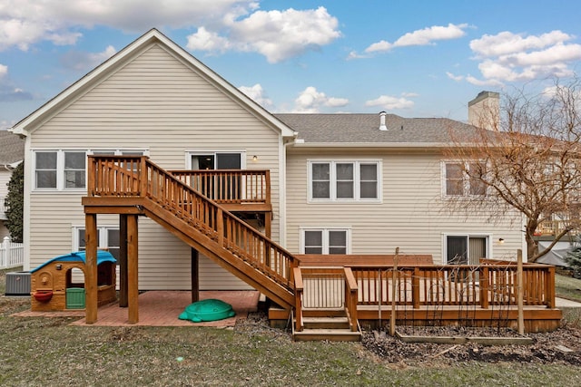 rear view of house with a patio area, central air condition unit, and a deck