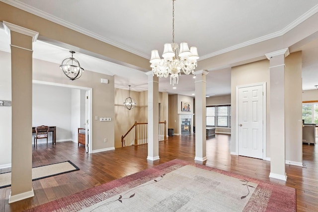 unfurnished dining area with decorative columns, a healthy amount of sunlight, and a notable chandelier