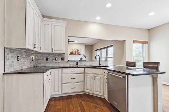 kitchen featuring white cabinetry, kitchen peninsula, sink, and dishwasher