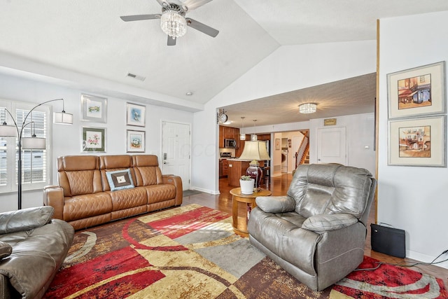 living room with lofted ceiling, hardwood / wood-style flooring, and ceiling fan