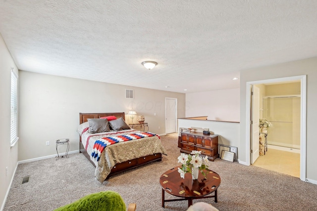 bedroom featuring connected bathroom, light carpet, and a textured ceiling