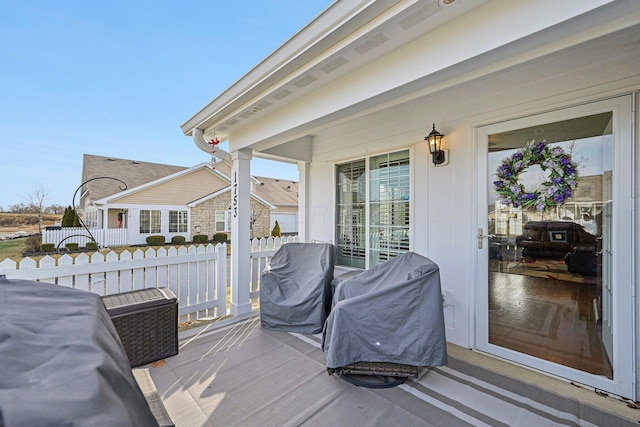 wooden deck featuring a grill and a porch