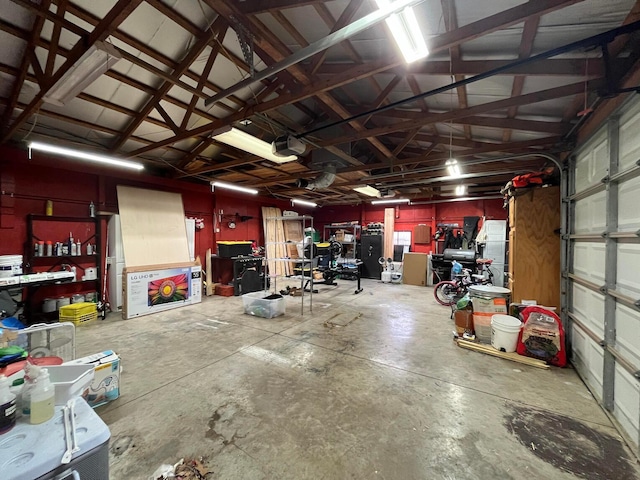 garage featuring a garage door opener and a workshop area