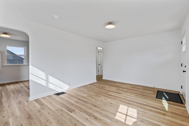 spare room with light wood-type flooring