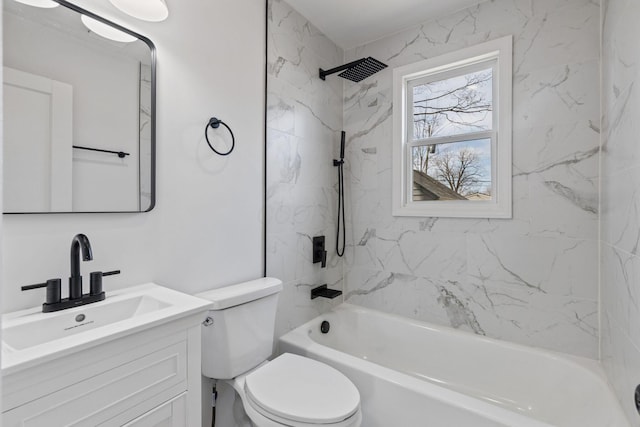 full bathroom featuring tiled shower / bath, vanity, and toilet