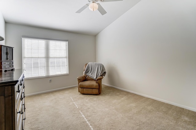 living area with lofted ceiling, light colored carpet, and ceiling fan