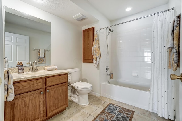 full bathroom with tile patterned flooring, vanity, toilet, and shower / bath combo with shower curtain