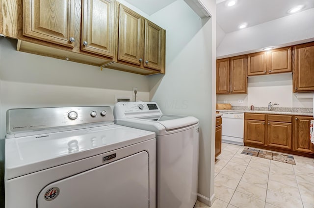 laundry room with sink, cabinets, and independent washer and dryer