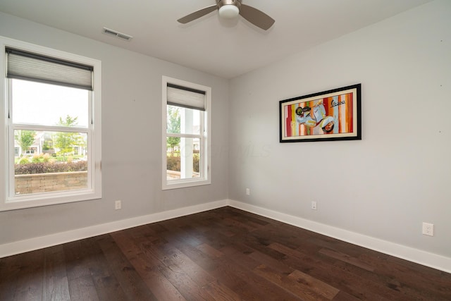 empty room featuring dark wood-type flooring and ceiling fan