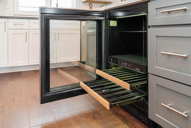 interior space with dark hardwood / wood-style flooring and white cabinetry