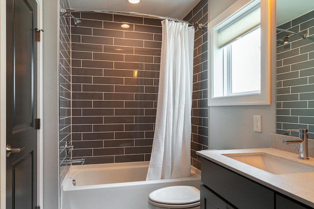 full bathroom featuring vanity, shower / bath combination with curtain, and toilet