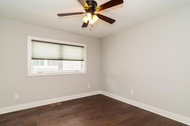 spare room featuring dark hardwood / wood-style floors and ceiling fan