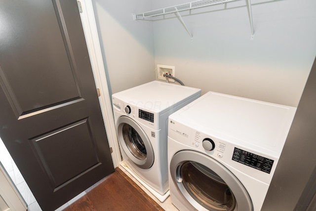 laundry room with dark wood-type flooring and washing machine and clothes dryer