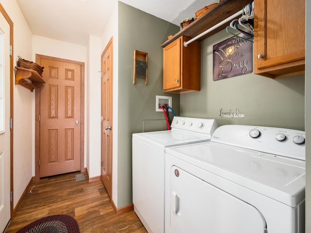 laundry room with washer and dryer, dark hardwood / wood-style flooring, and cabinets