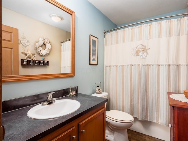 bathroom featuring vanity, toilet, and walk in shower